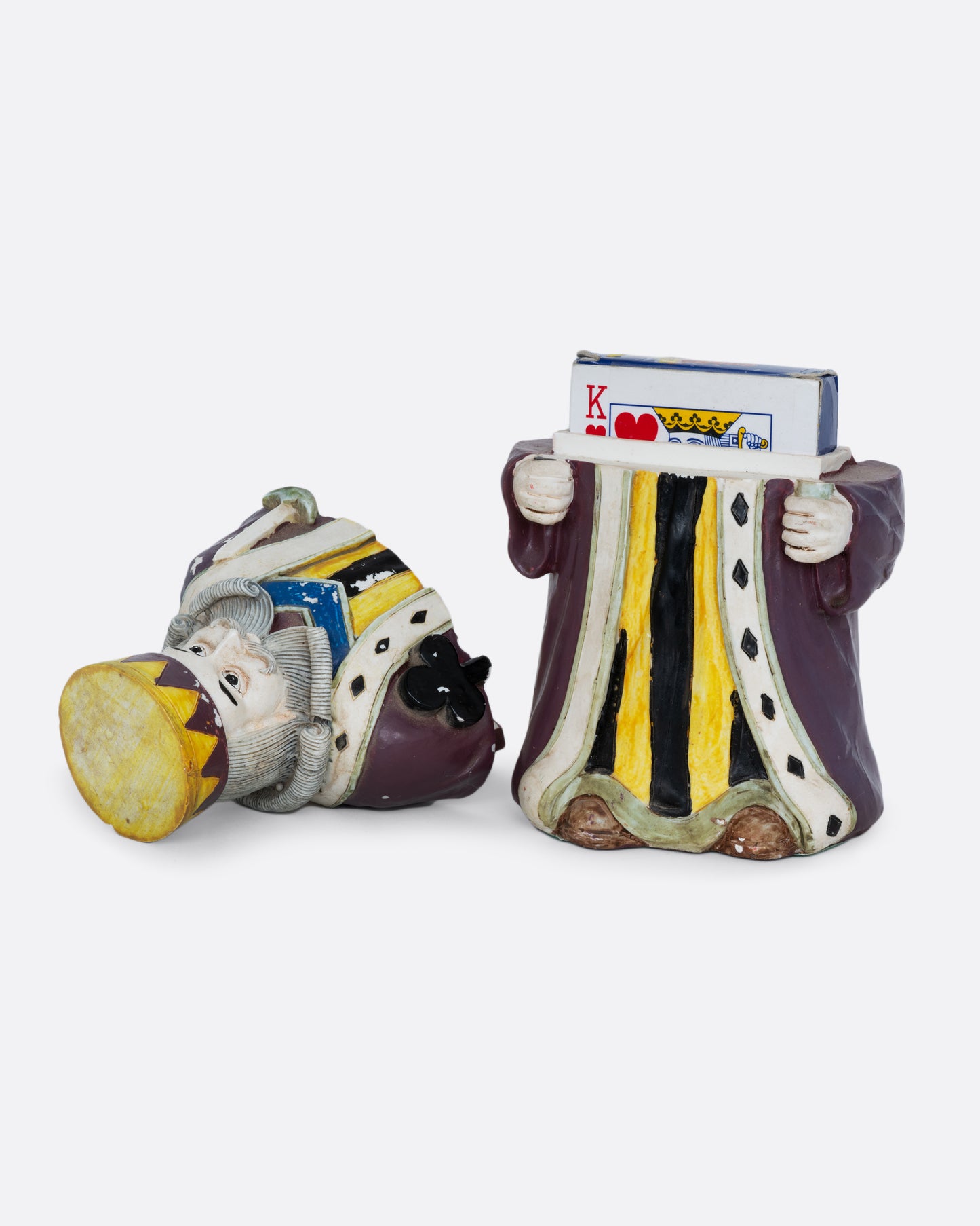 A card holder king of clubs figurine with a purple robe and crown, shown open from the front with paying cards inside.