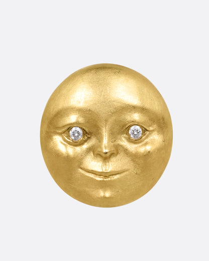 A yellow gold moon face stud earring with diamond eyes. Shown from the front.