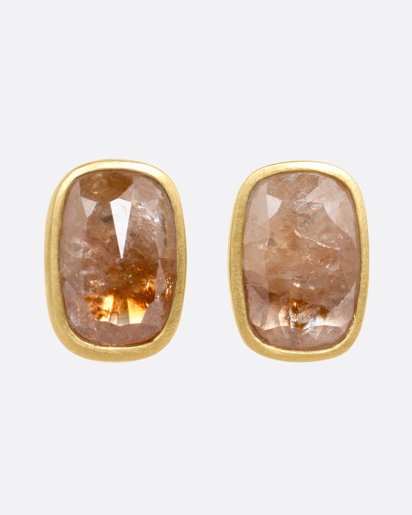 A pair of yellow gold rectangular salt and pepper stud earrings, shown from the front.