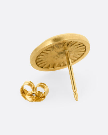 A yellow gold moon face stud earring with diamond eyes. Shown from the back open.