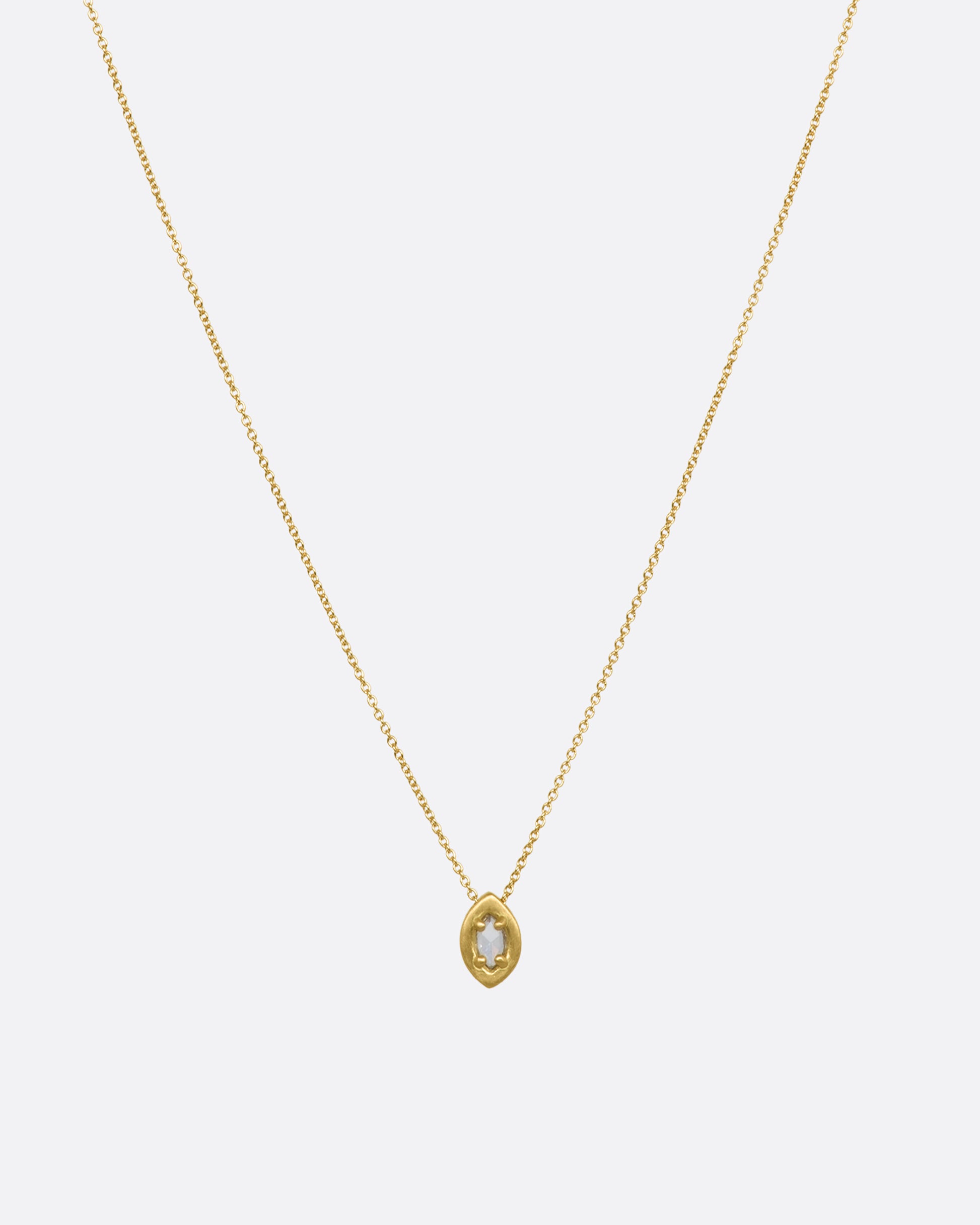 A yellow gold necklace with a prong set marquise diamond pendant. View from the front.