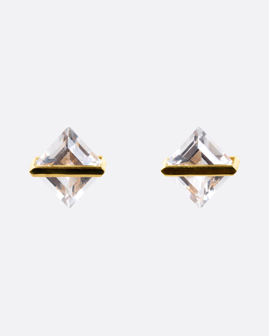 A pair of rhombus shaped quartzes, each in an open yellow gold bar stud earring setting. Shown from the front.