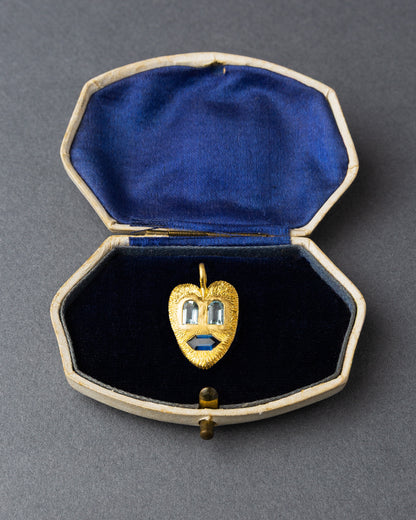 Yellow gold heart face pendant with aquamarine and sapphire in a vintage jewelry box lined with blue velvet