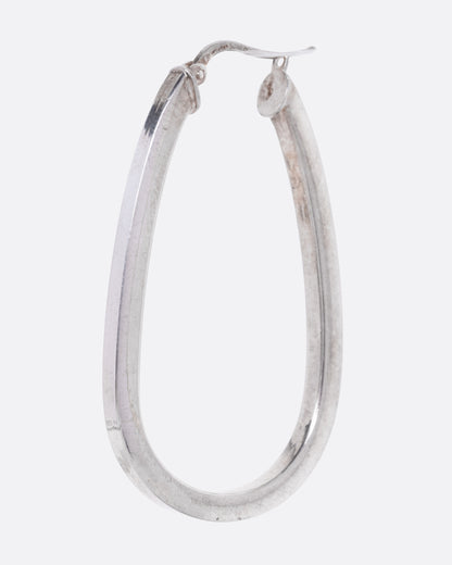 A silver hoop earring with a squared edge and oval shape, shown from the side.
