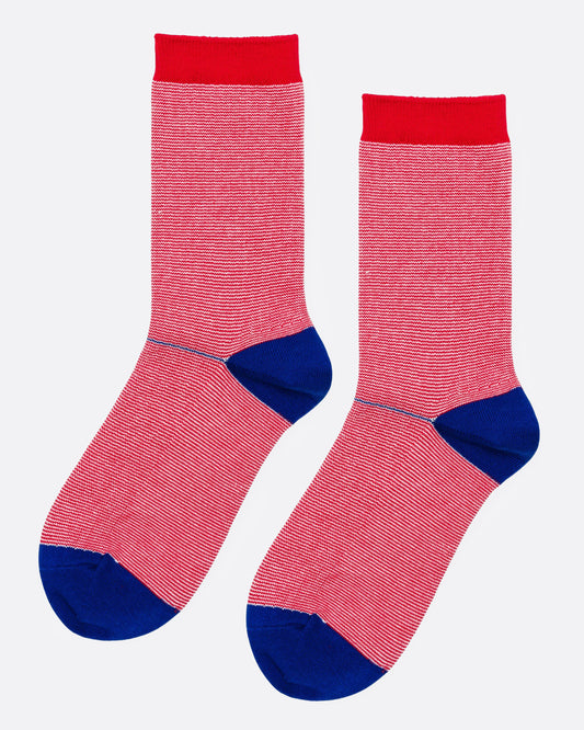 A pair of crew socks with red stripes, solid red cuffs, and blue heels and toes, shown from the side.