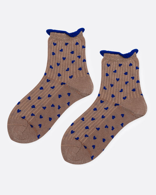A pair of ankle socks in a warm taupe-brown color, featuring a pattern of small blue hearts and a solid blue ribbed cuff, shown from the side.