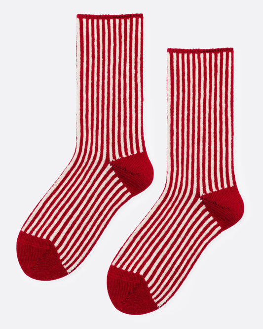 A pair of red and white vertically striped crew socks with solid red heels, toes, and cuffs, shown from the side.