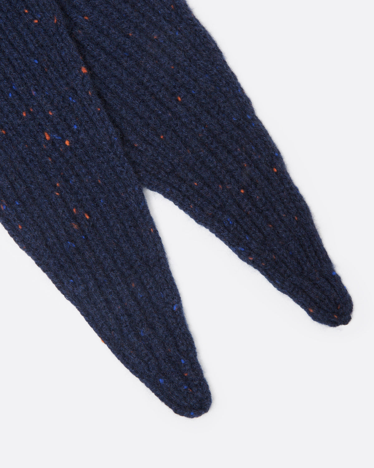 A close up of a navy blue ribbed knit scarf with tiny multicolor flecks.