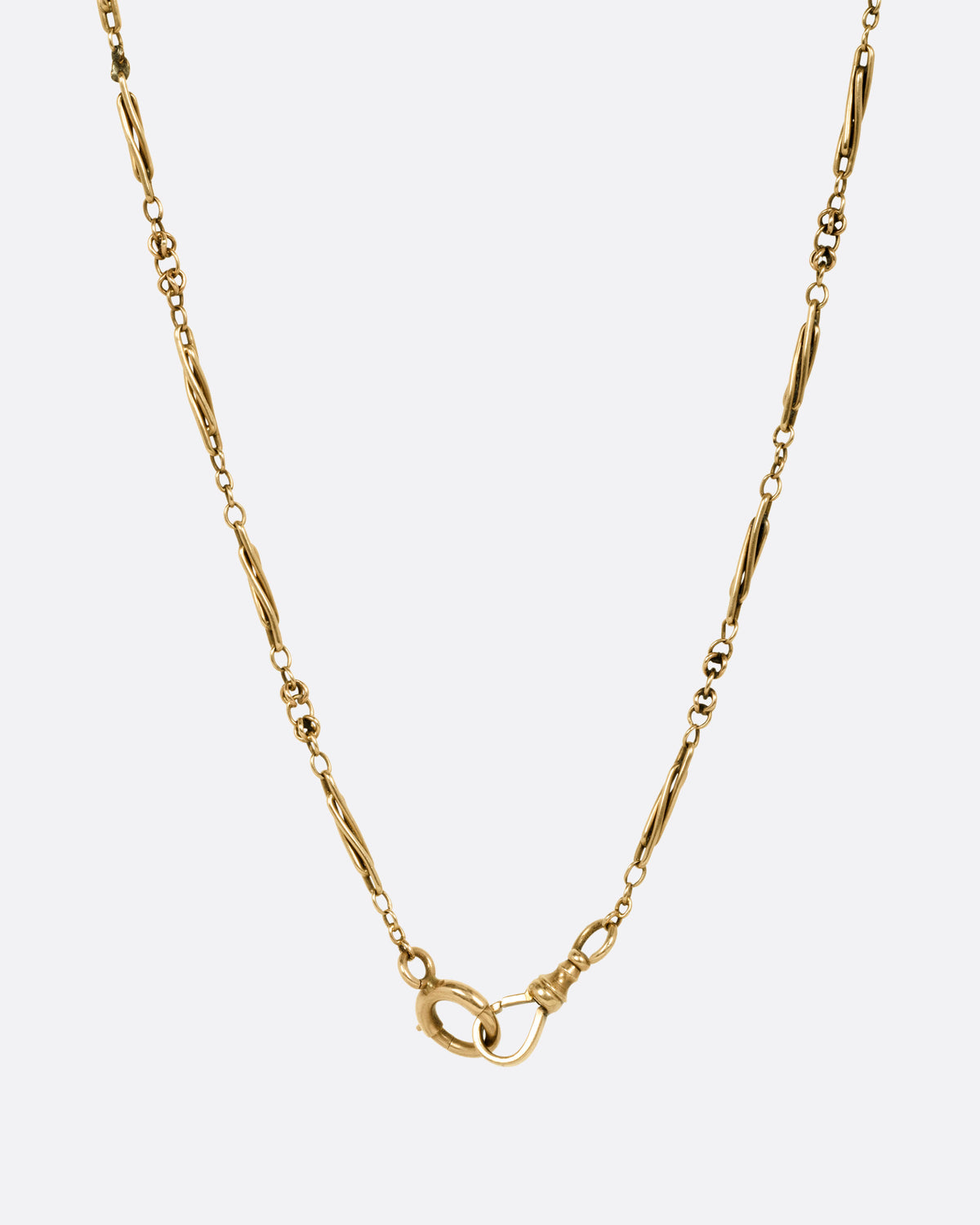 A yellow gold watch chain necklace with long twisted links, shown from the back.