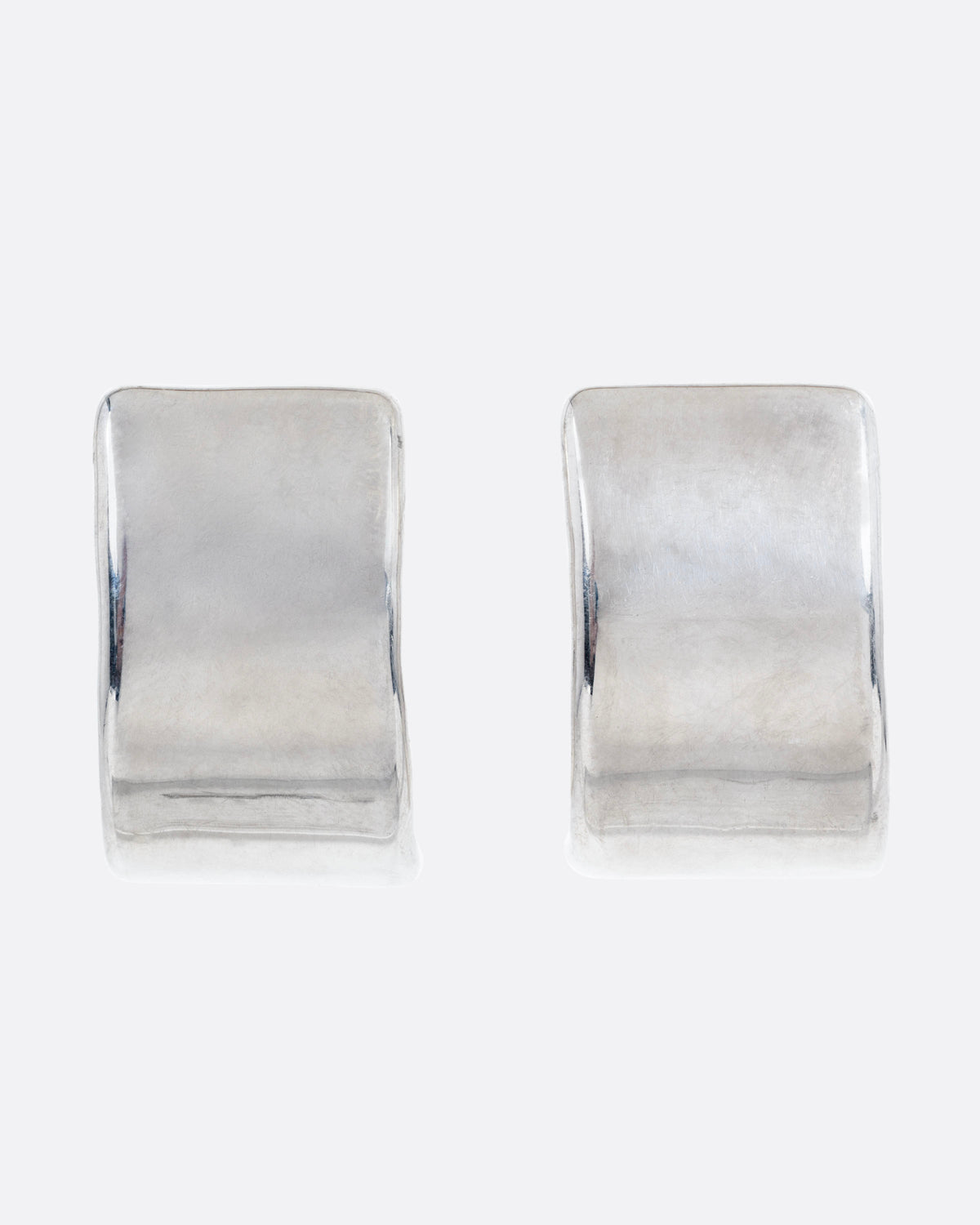 A pair of silver rectangular curved earrings, shown from the front.