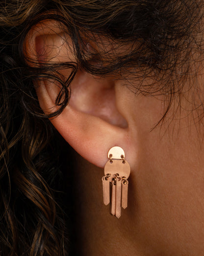 Lori Leven Double Dot fringe earring in rose gold worn on an ear, two stacked half-circle discs with a fringe of flat gold sticks