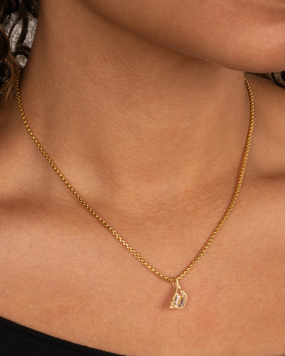 Yellow gold goshenite pendant charm worn on a chain