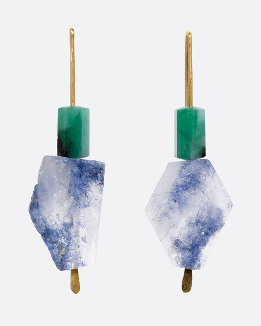 A pair of yellow gold hook earrings with a freeform dumortierite and emerald on each. Shown from the front.