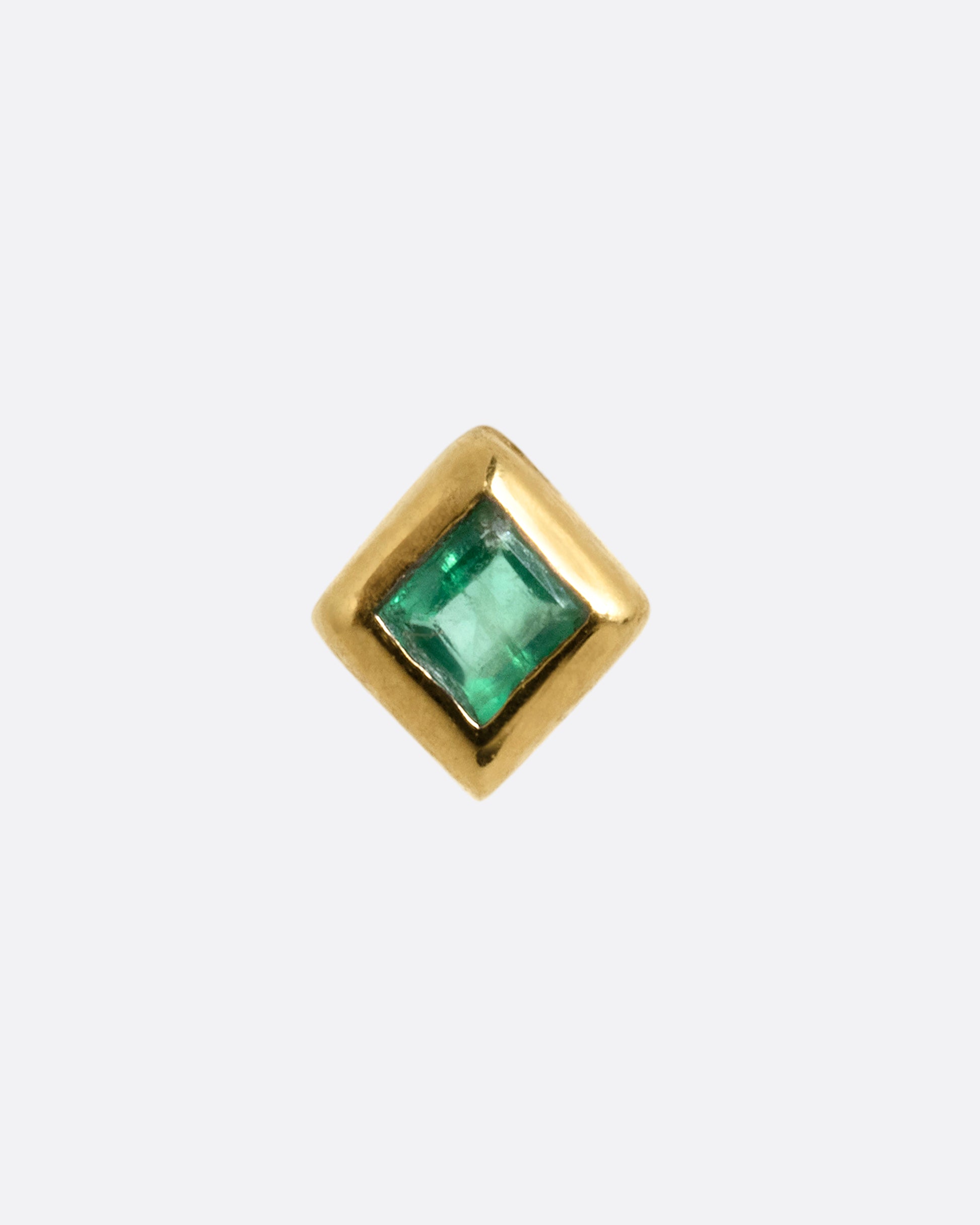 A yellow gold stud earring with a princess cut emerald, shown from the front.