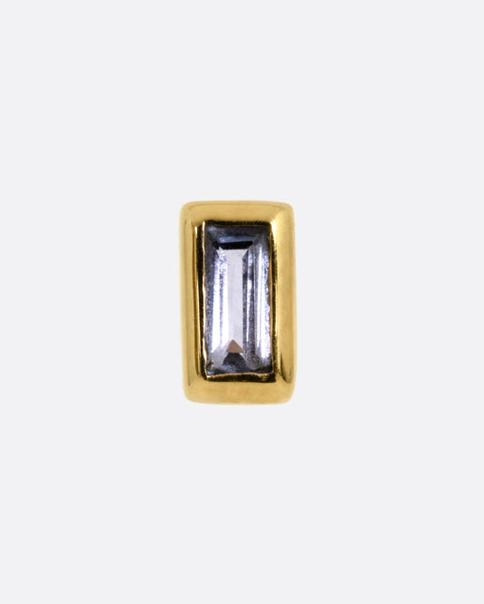 A yellow gold stud earring with a baguette cut tanzanite, shown from the front.