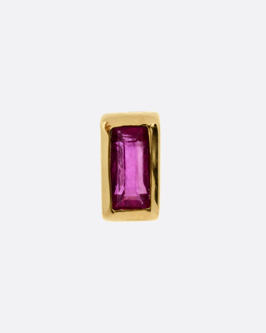 A yellow gold stud earring with a baguette cut ruby, shown from the front.