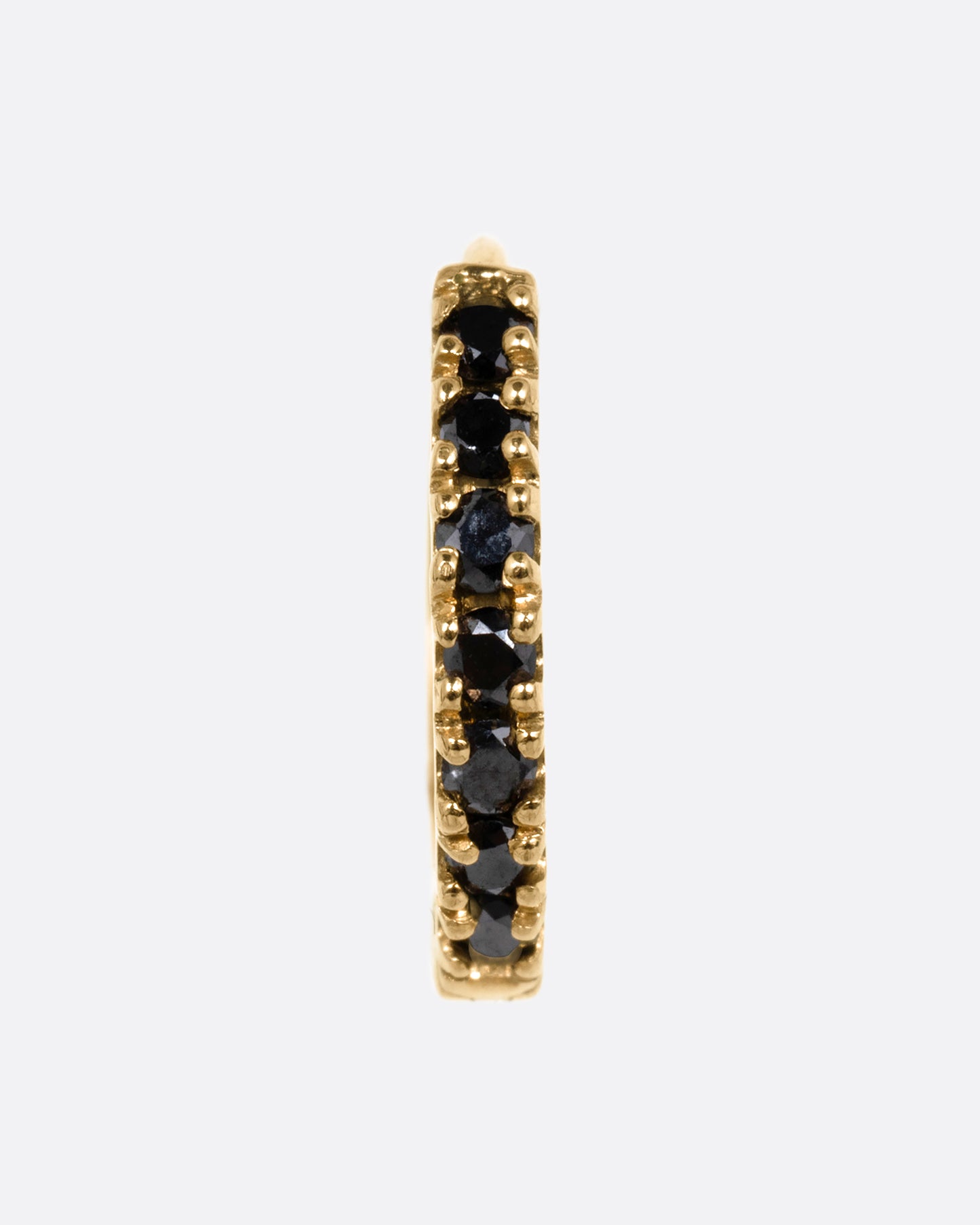 A yellow gold hinged hoop earring with black pavé diamonds, shown from the front.