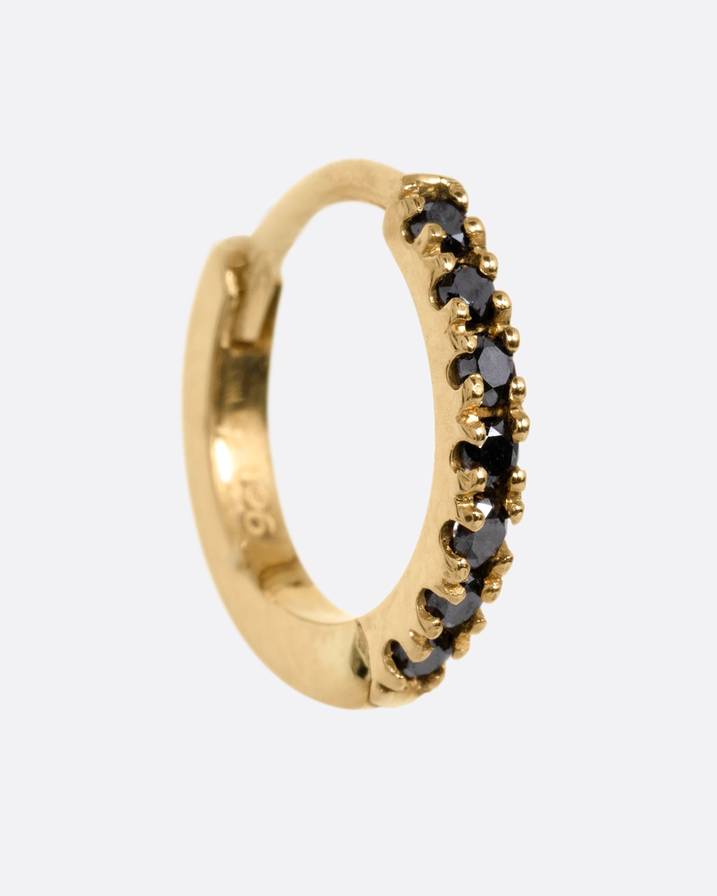 A yellow gold hinged hoop earring with black pavé diamonds, shown from the side.
