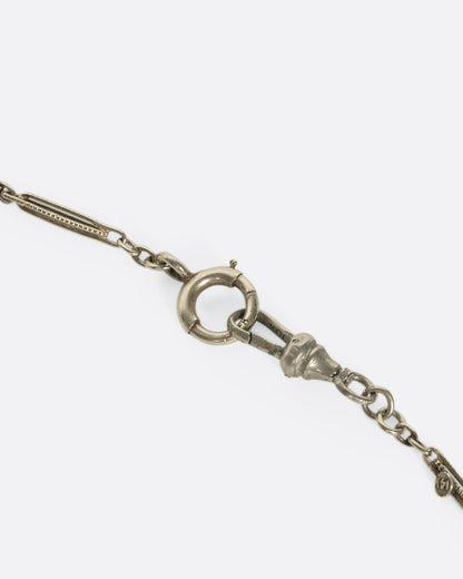 Vintage white gold and enamel bar link necklace, close view of the spring ring clasp