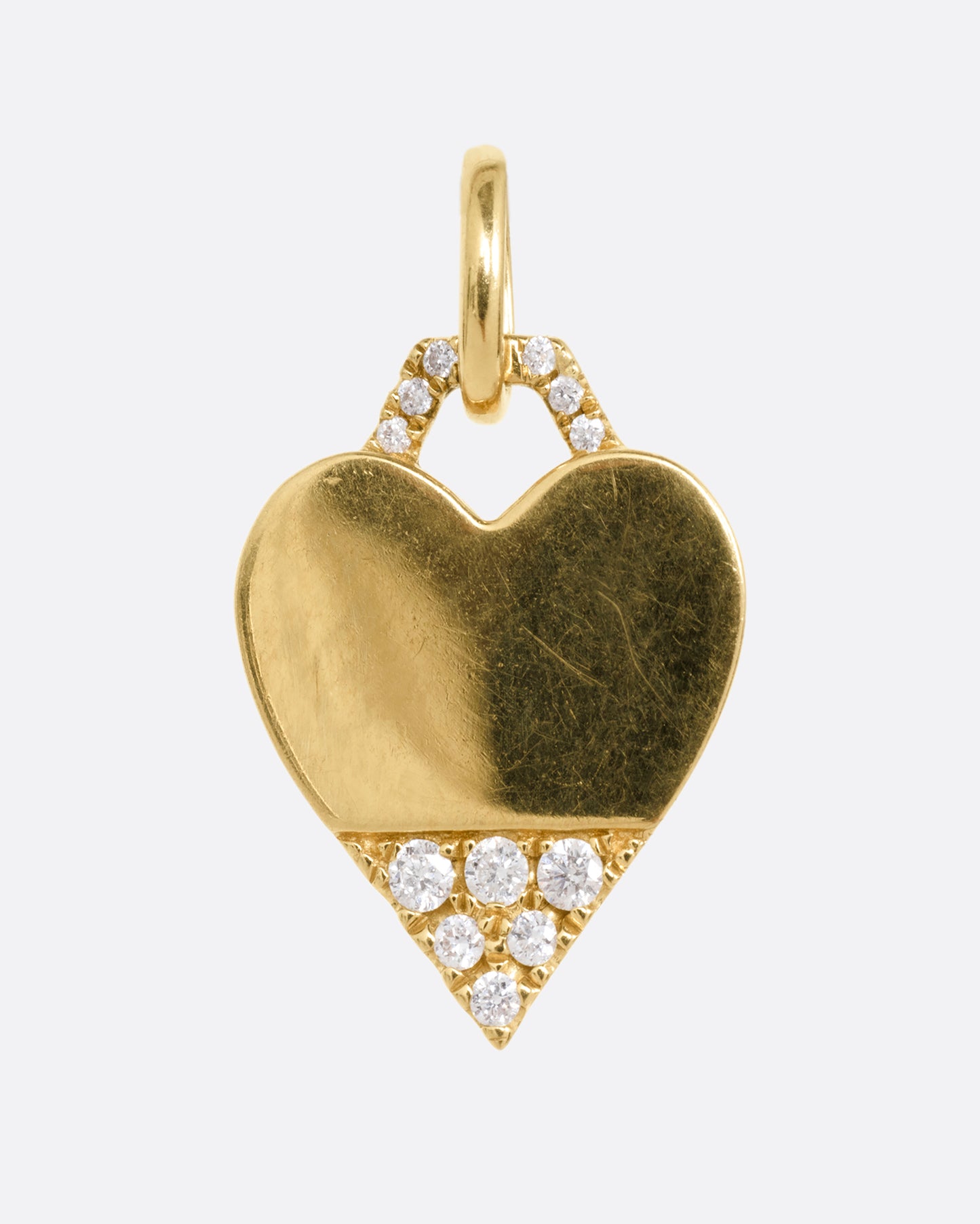 A yellow gold heart pendant with a diamond studded bail and tip, shown from the front.