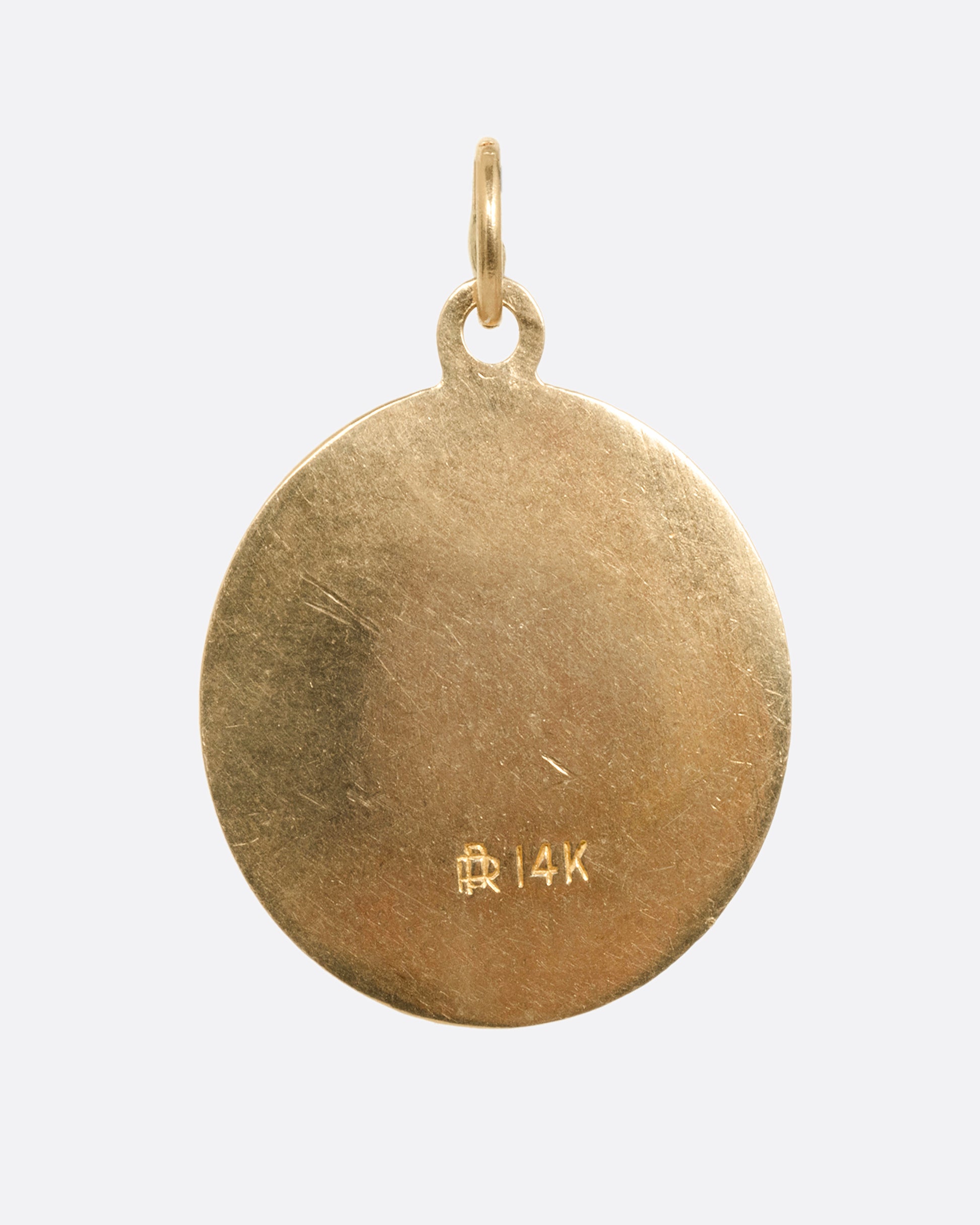 A round yellow gold Saint Christopher pendant, shown from the back.