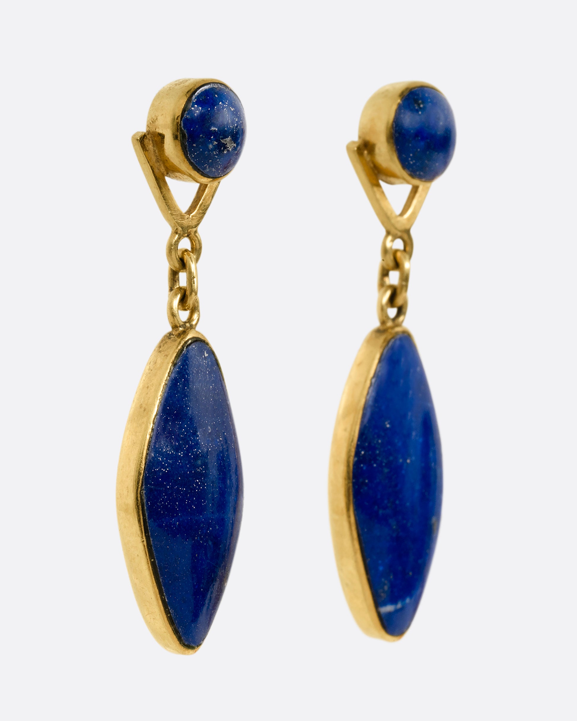 A pair of yellow gold lapis drop earrings with round lapis stud tops. Shown from the side.