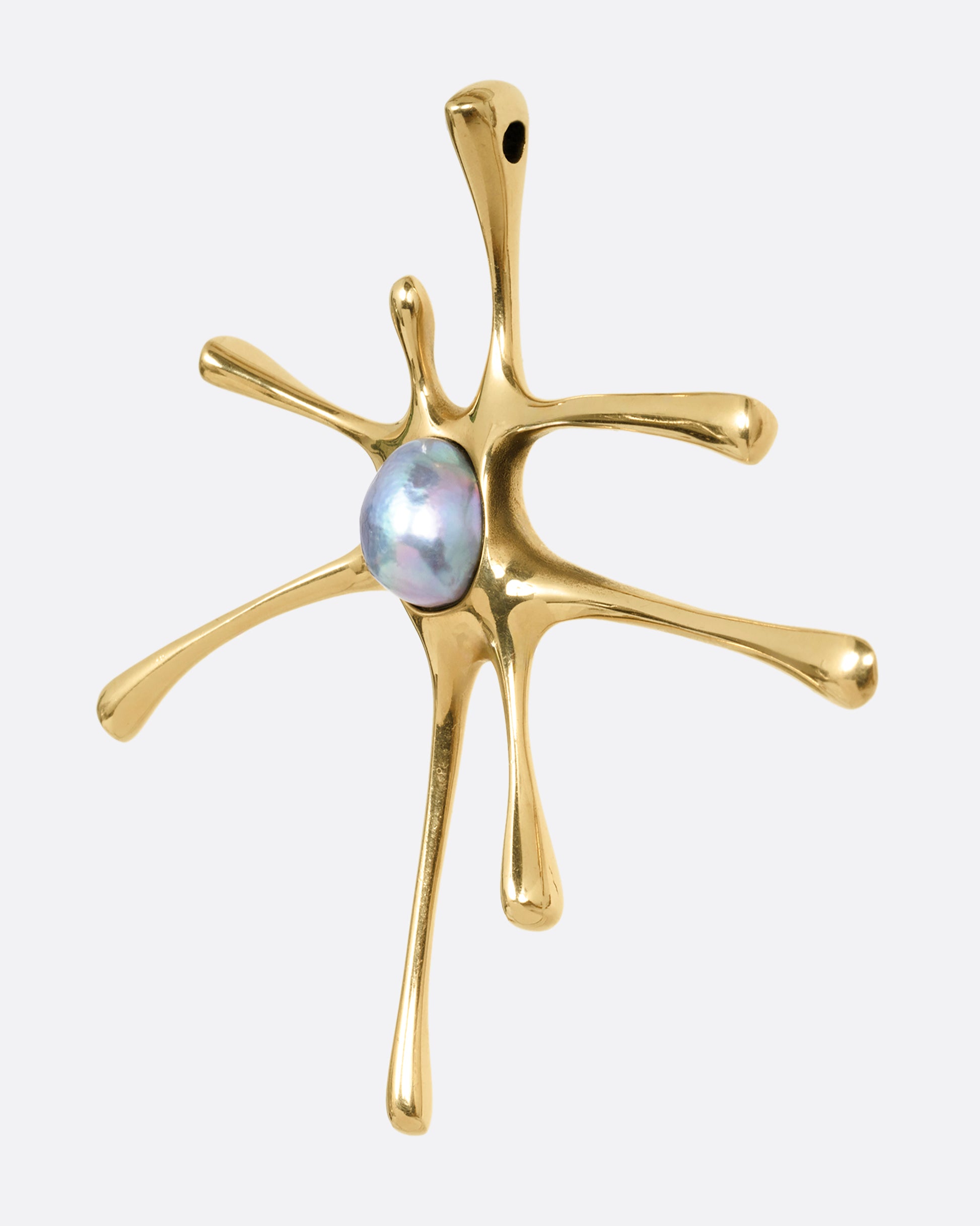 A yellow gold amoeba shaped pendant with a central pearl, shown from the side.
