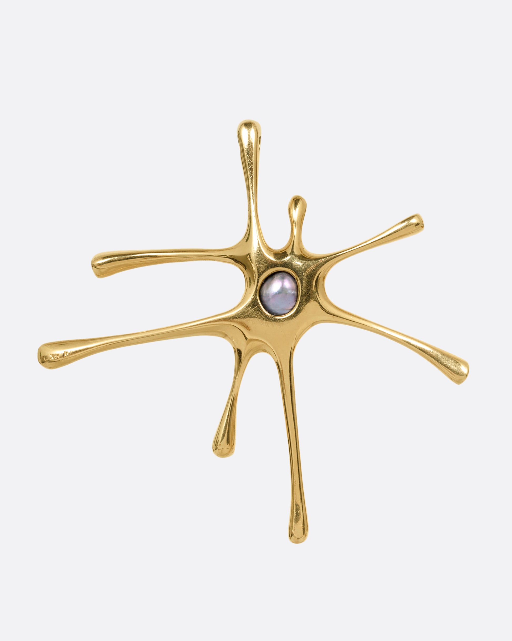 A yellow gold amoeba shaped pendant with a central pearl, shown from the back.