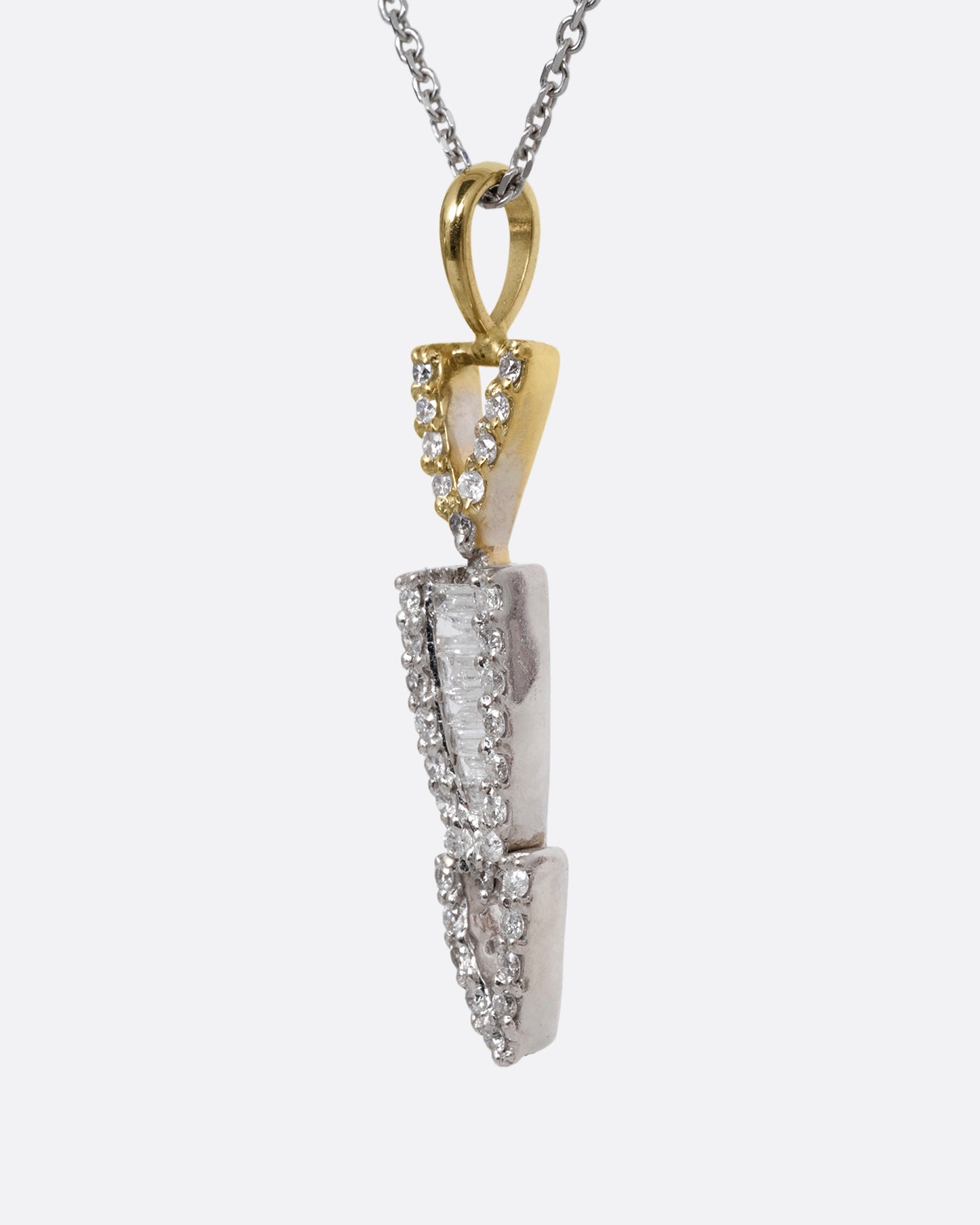 A white gold cable chain necklace with a diamond studded stack of arrows. Shown from the side.