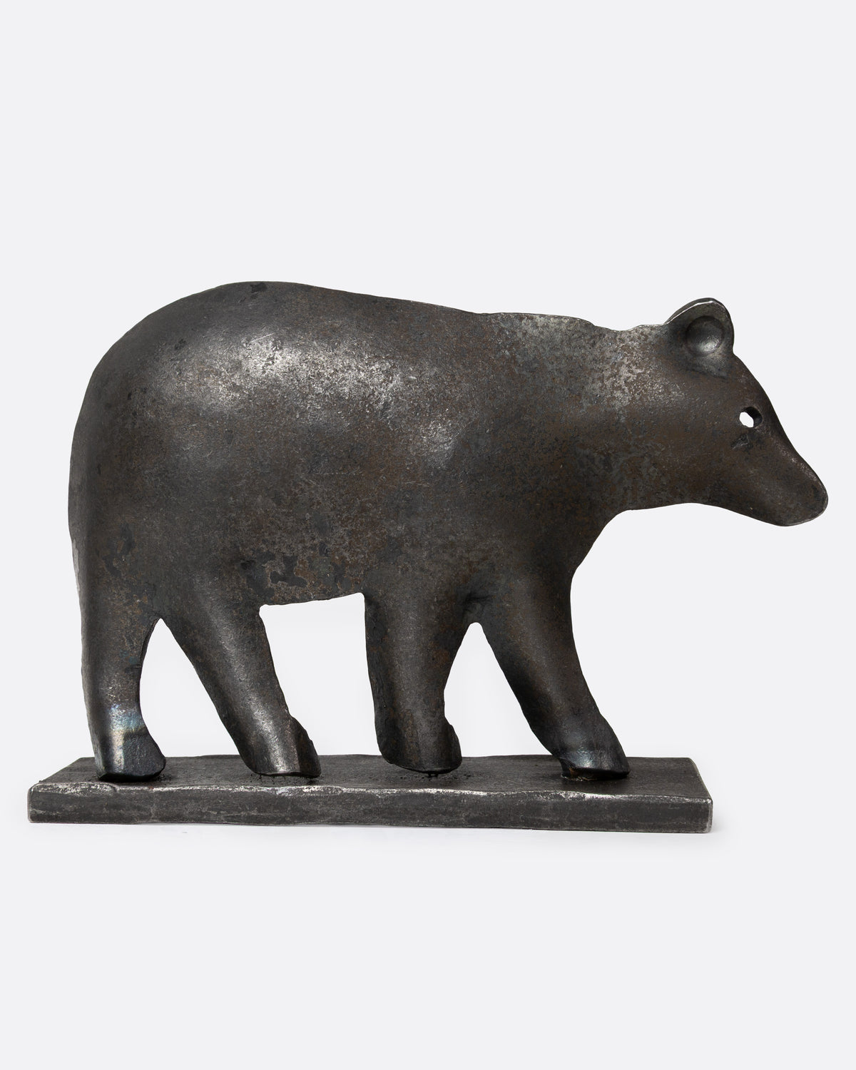 A forged iron bear figurine, shown from the side.