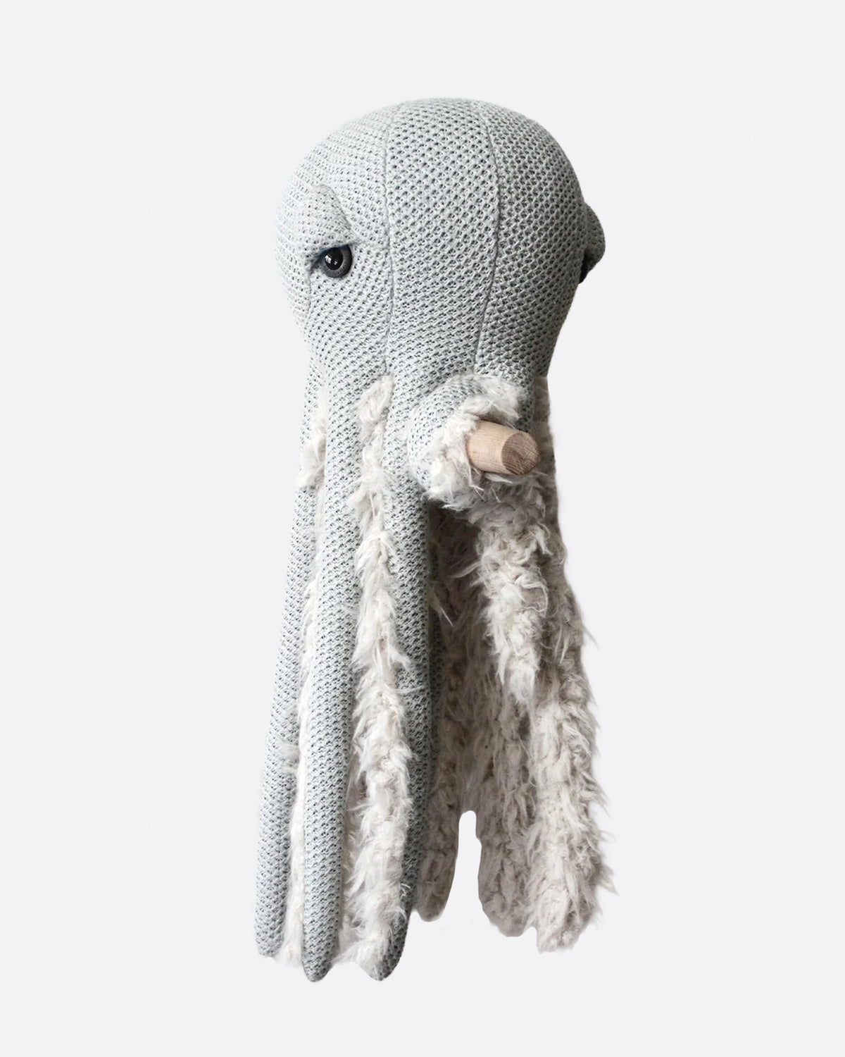 Gray knit stuffed octopus holding a wooden cane, front view.