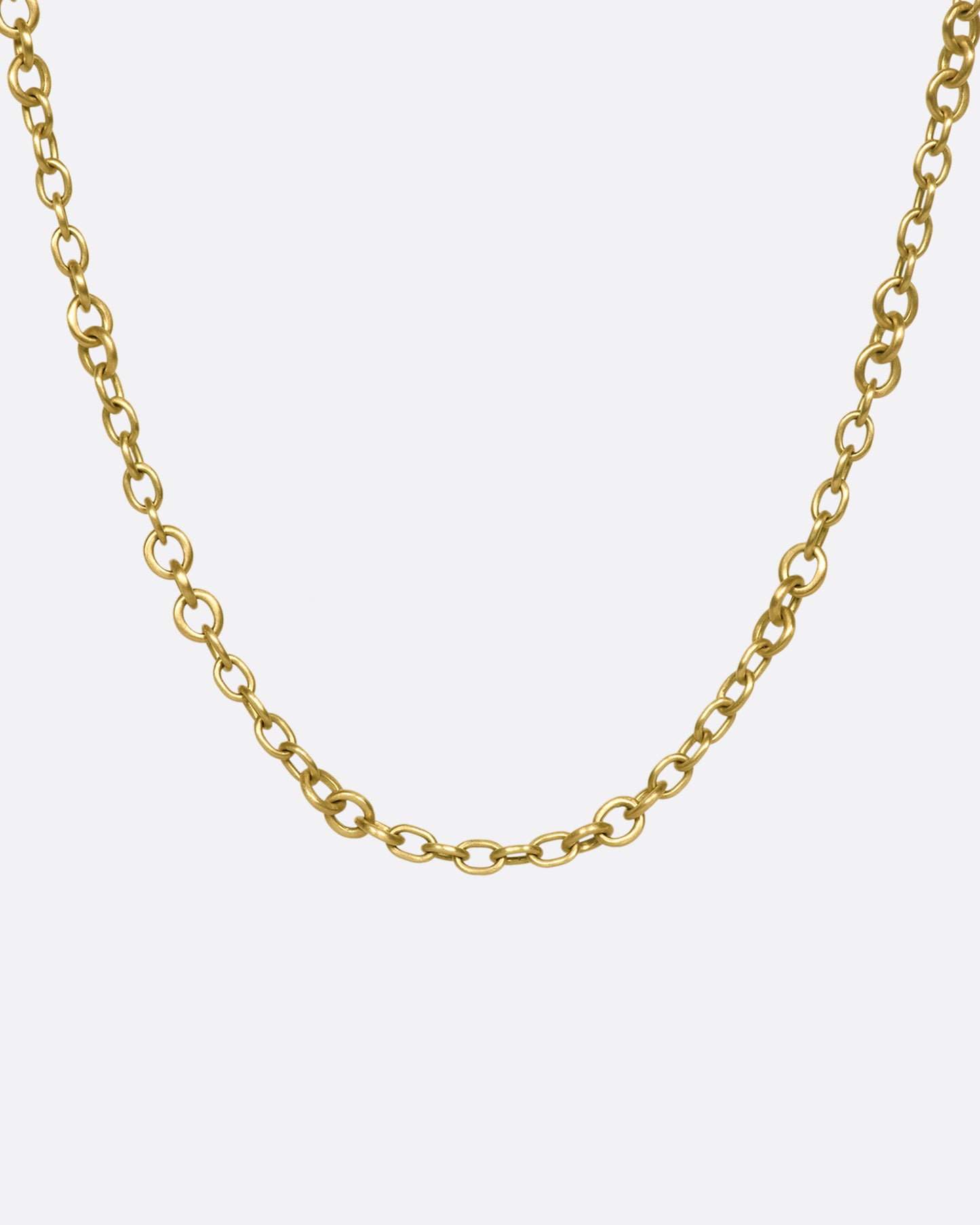 A beautiful 18K gold chain that will rest along your collar bone. Heavy enough to wear on its own in a neck mess and fine enough to add a pendant or two.