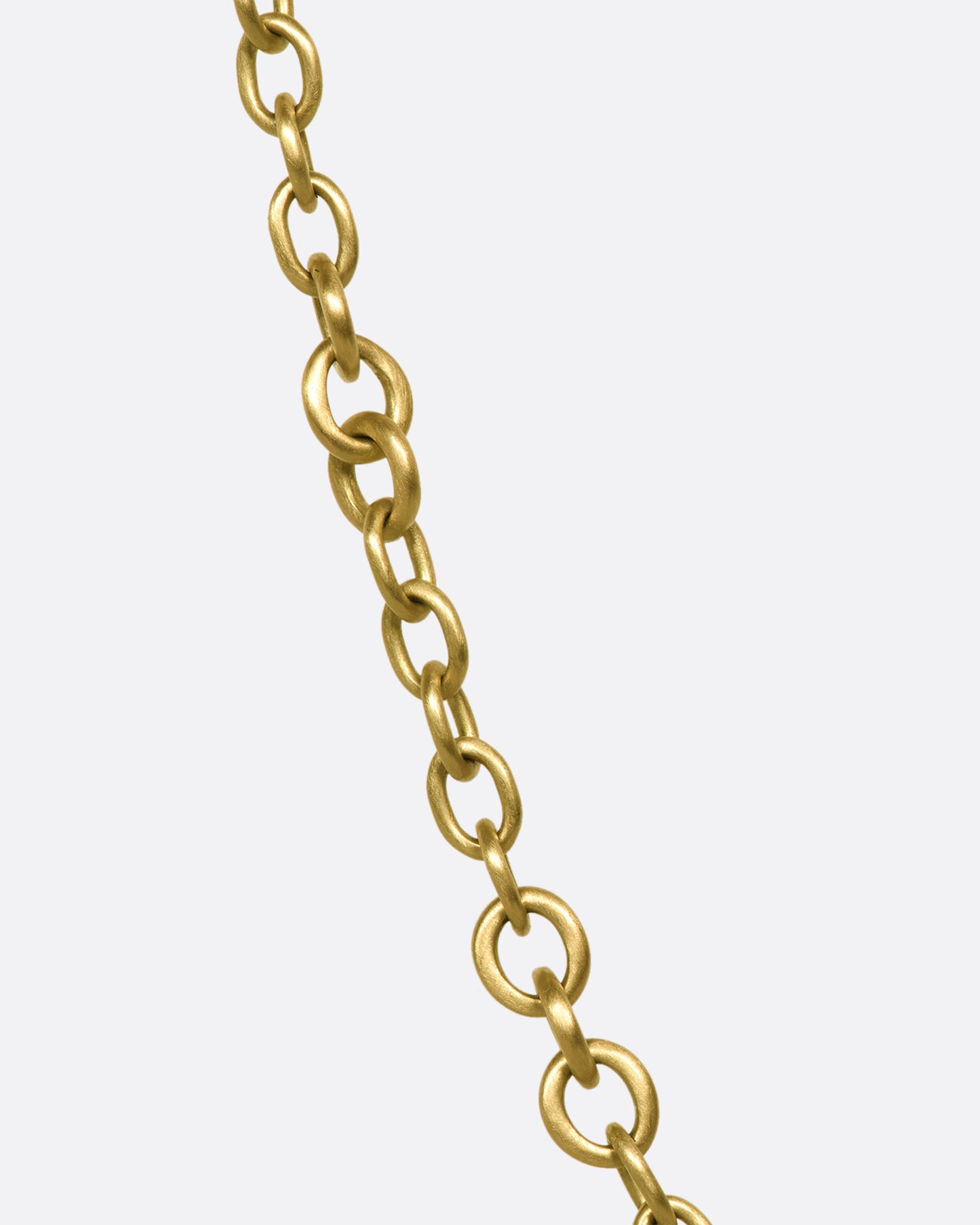 A beautiful 18K gold chain that will rest along your collar bone. Heavy enough to wear on its own in a neck mess and fine enough to add a pendant or two.