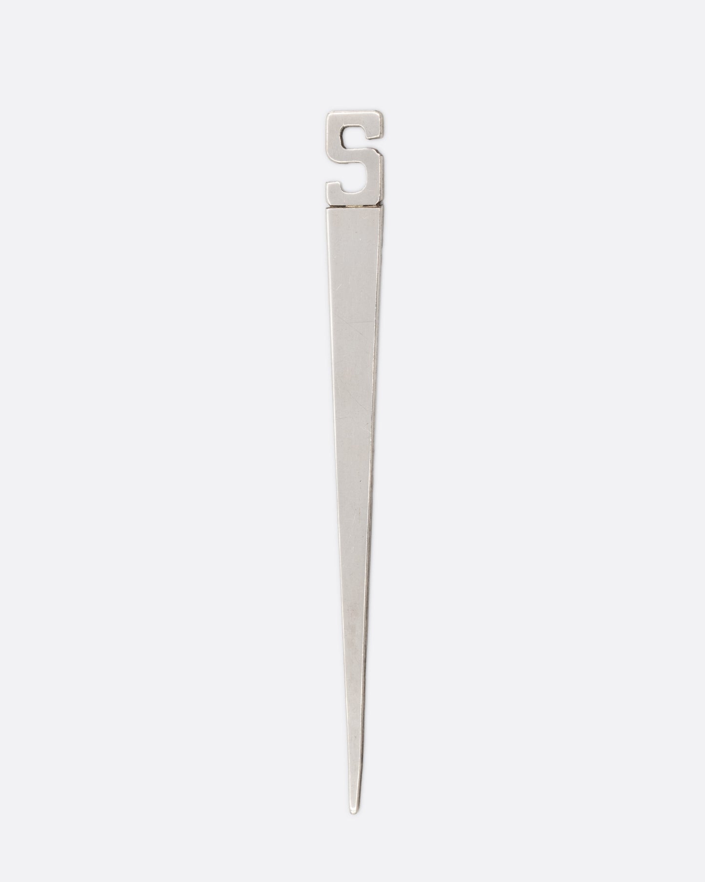 A silver pointed bookmark with a letter 'S' at the top. Shown from the front.