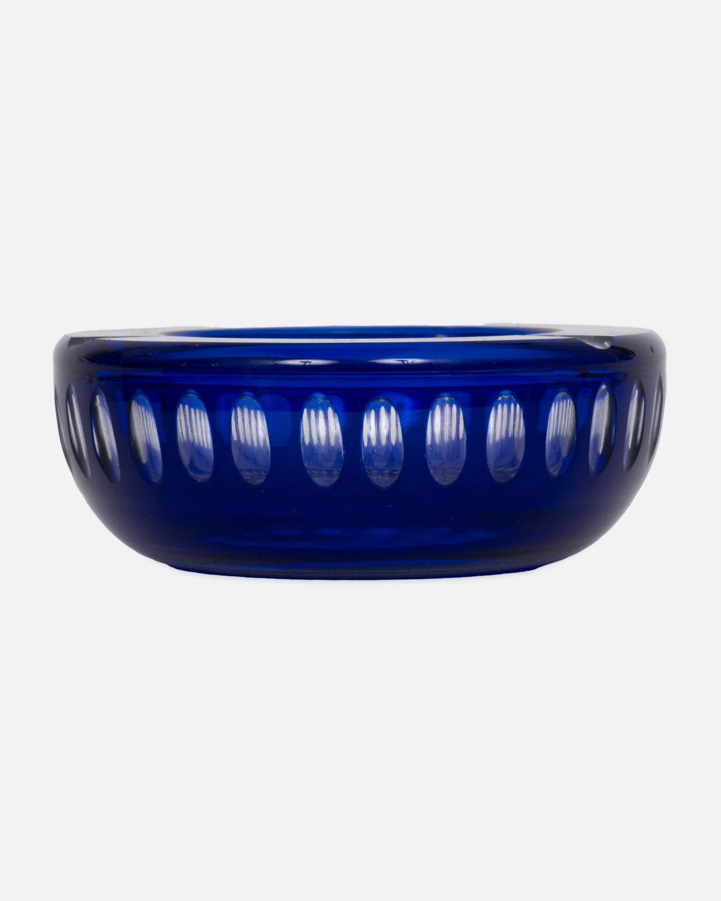 A blue glass ashtray with a bubbly design, shown from the front.