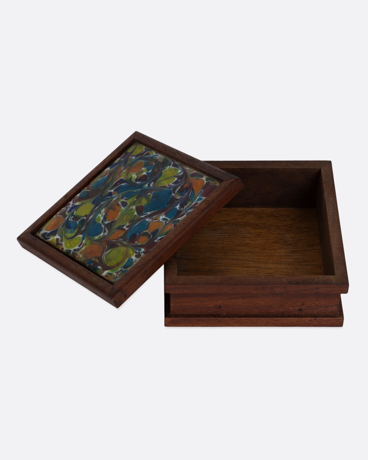 A wooden cigarette box with an abstract enamel design. Shown open from the front.