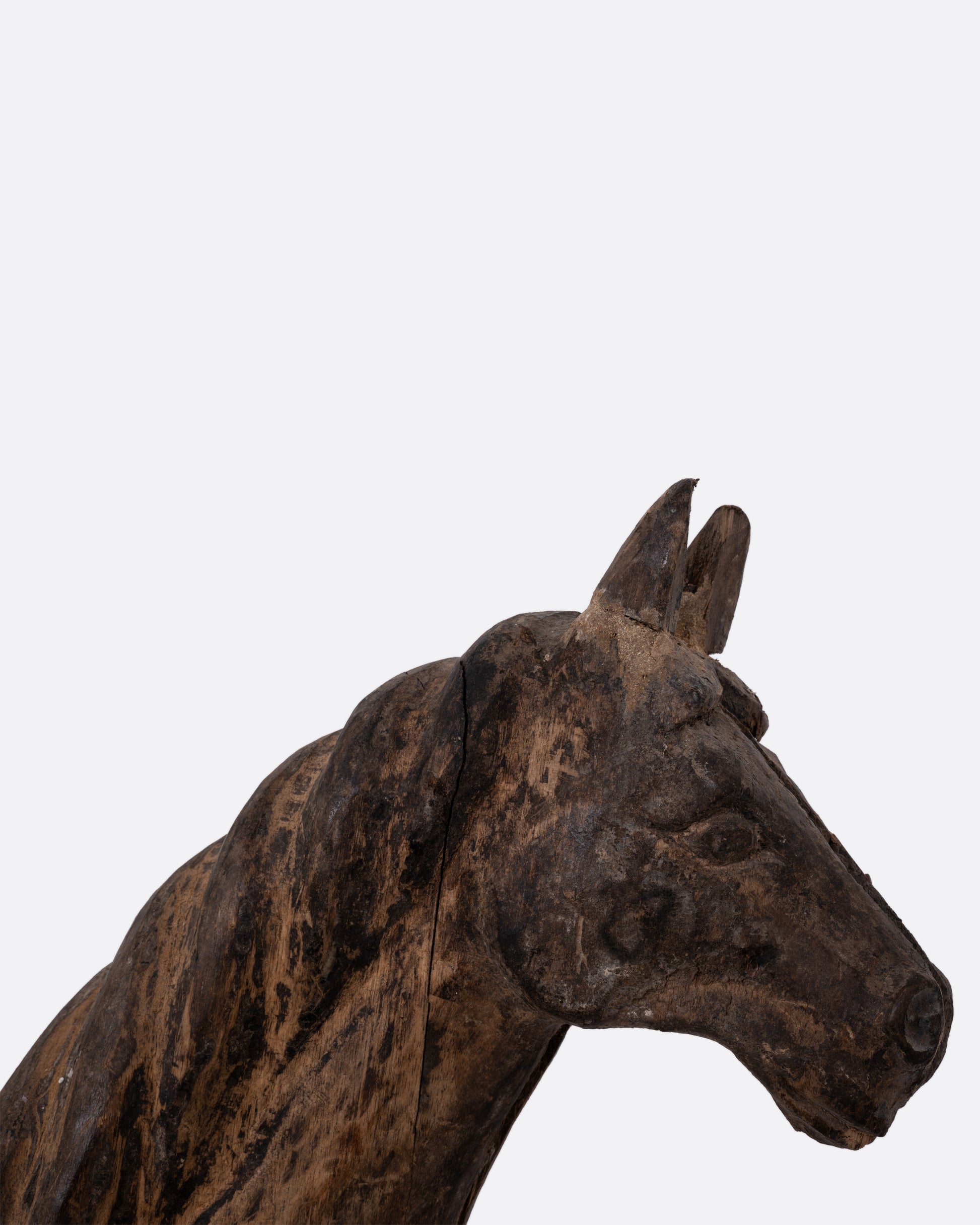 A close up of a wooden horse  takaan sculpture.