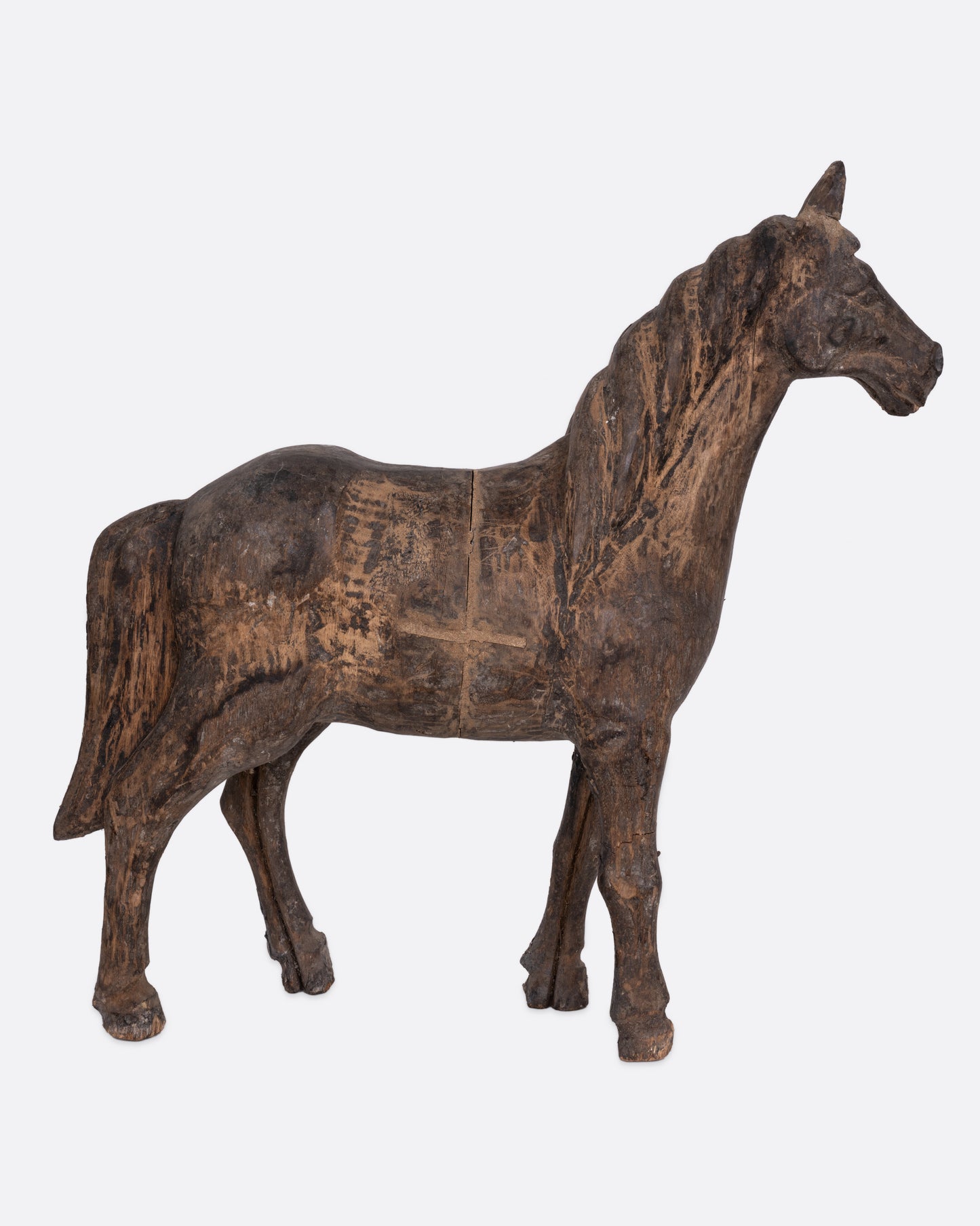 A wooden horse  takaan sculpture shown from the side.