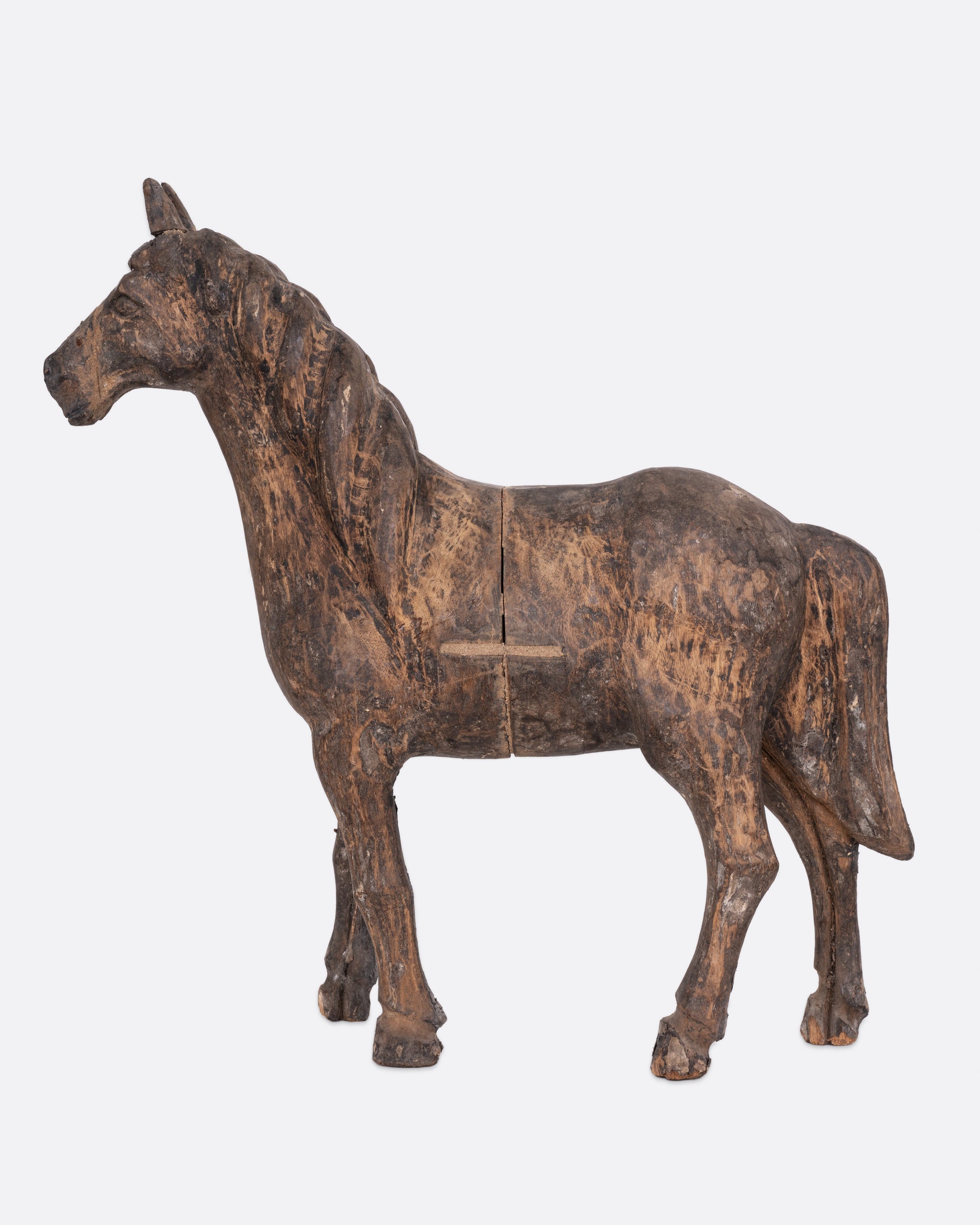A wooden horse  takaan sculpture shown from the side.