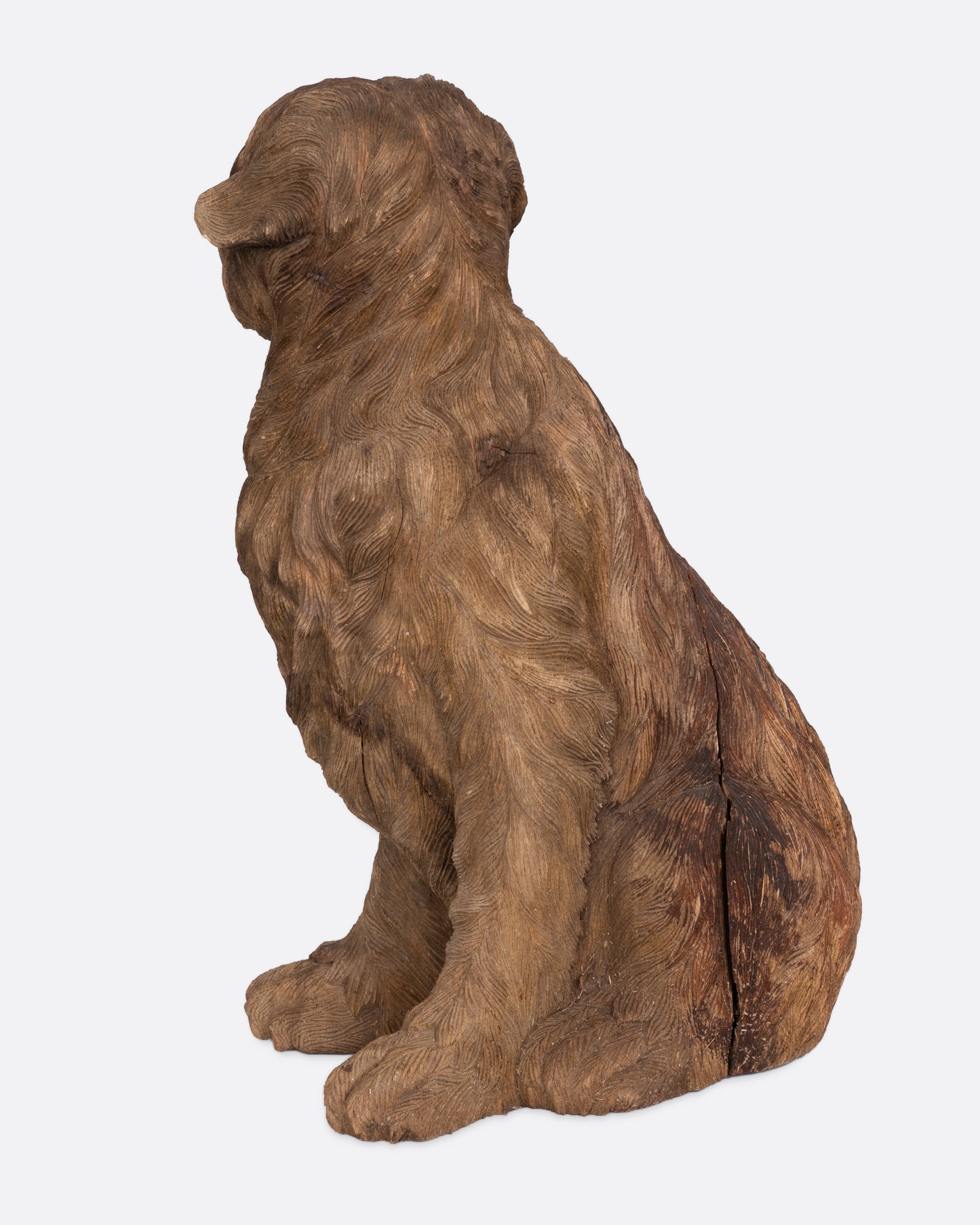 A wooden dog takaan sculpture shown from the back.