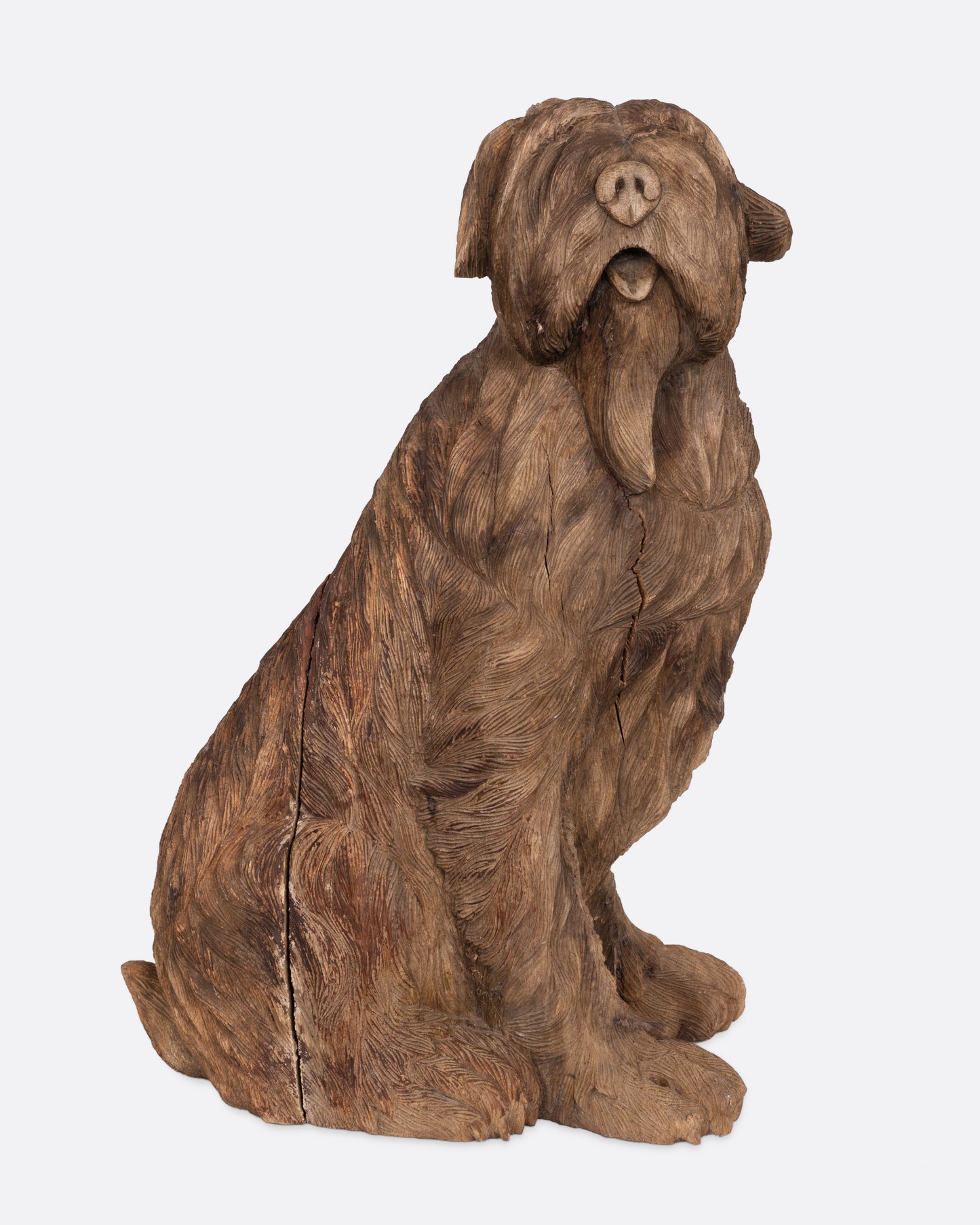 A wooden dog takaan sculpture shown from the front.