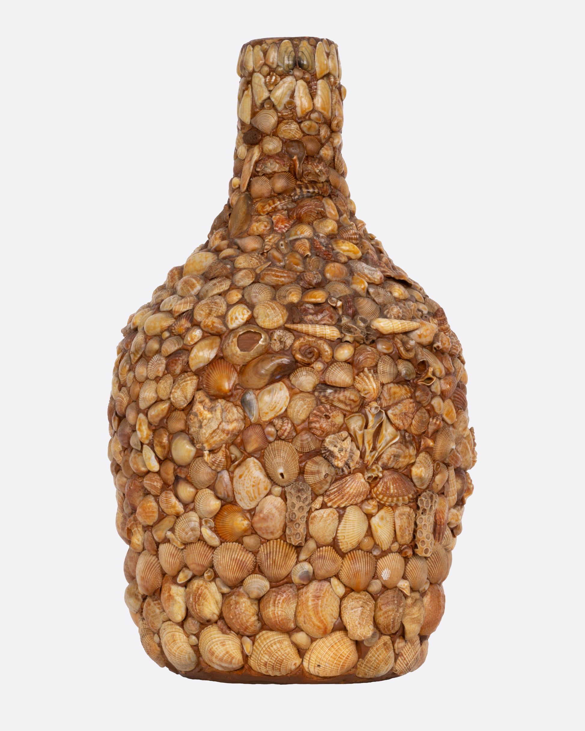 A bottle covered in shells to create a mosaic, shown from the front.