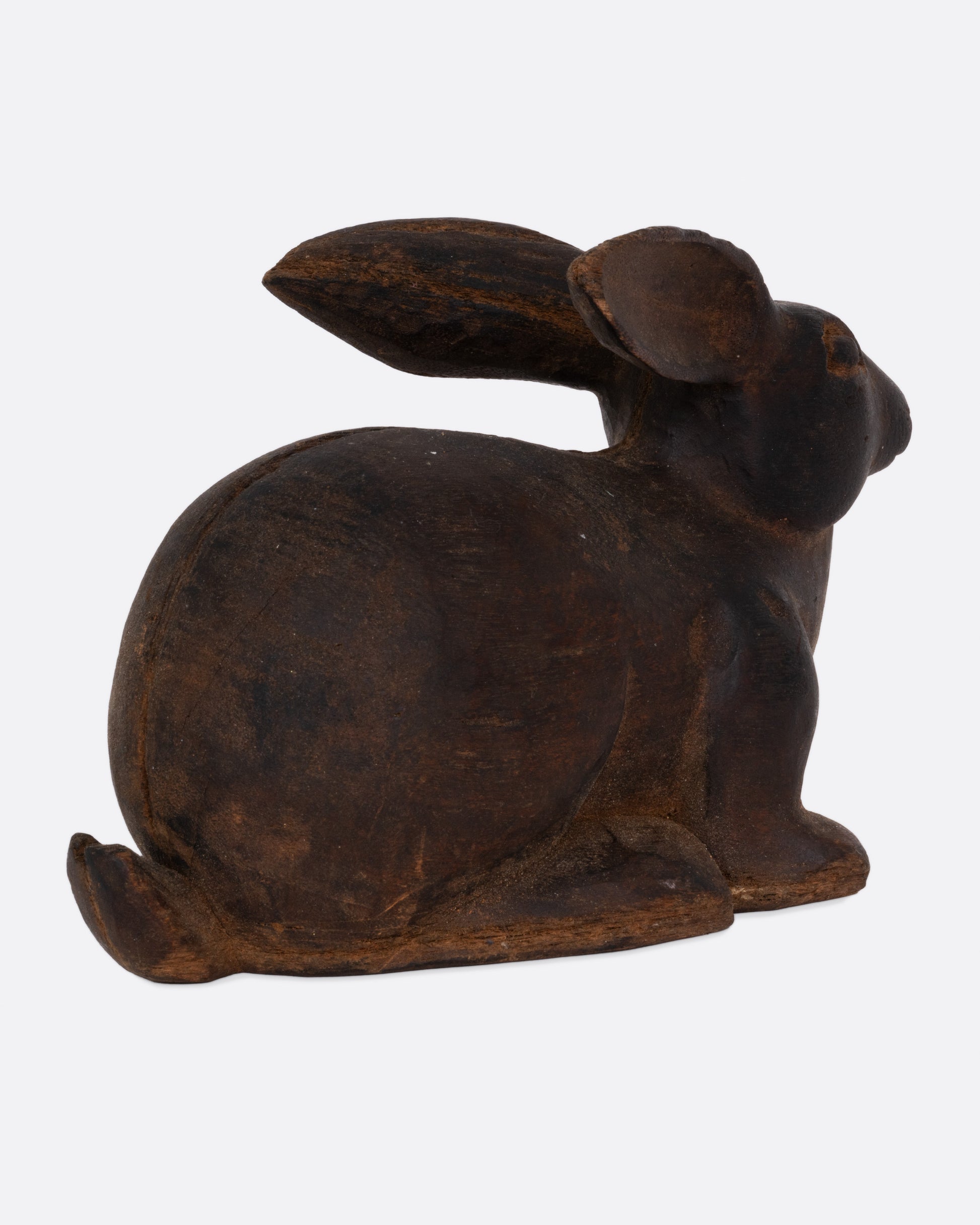 A wooden rabbit takaan sculpture shown from the side.