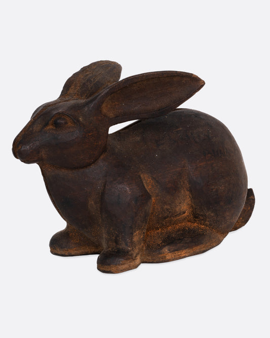 A wooden rabbit takaan sculpture shown from the side.