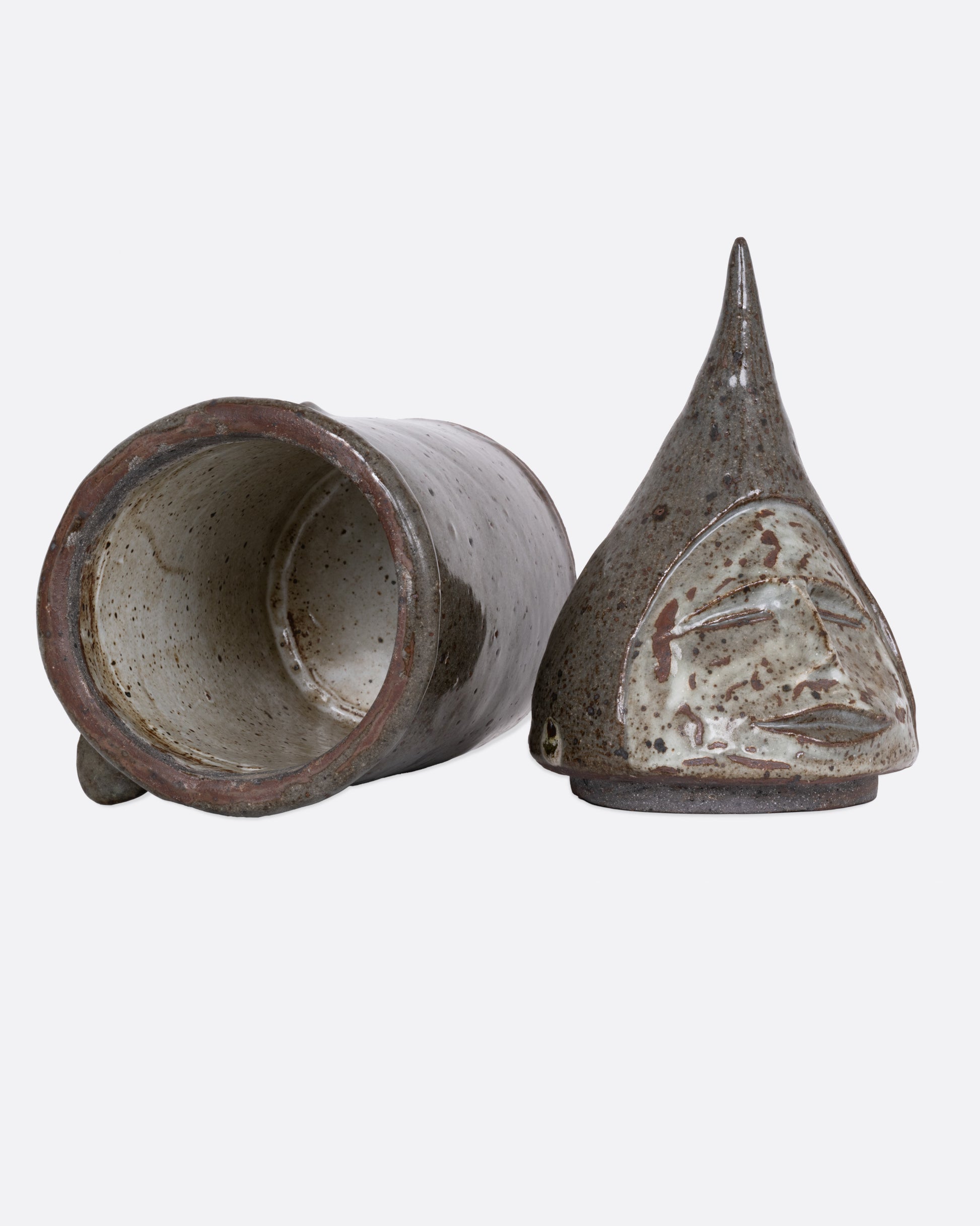 A this ceramic likeness of Saint Fiacre with a removable lid, shown open on its side.