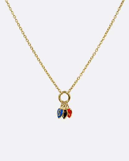 A yellow gold cable chain necklace with a charm holder and three heart shaped charms- one blue with a B, one black with a T, and one red with an N. Shown from the front.