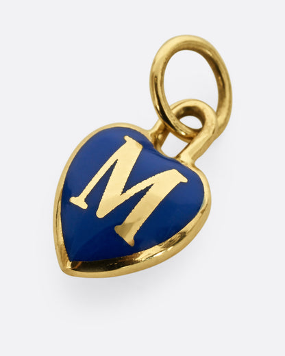 A yellow gold heart shaped pendant with blue enamel and a letter M, shown from the front.