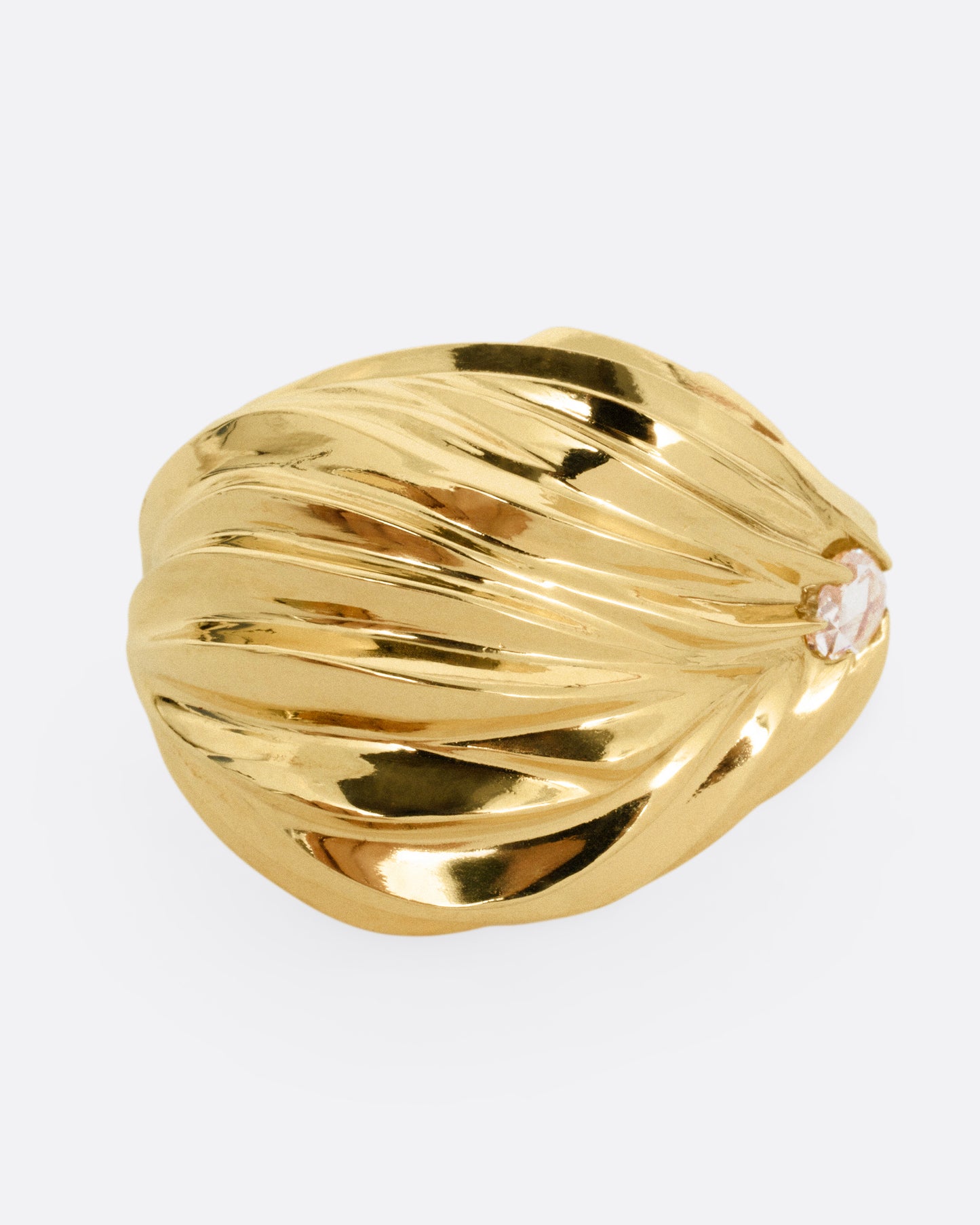 A yellow gold textural dome ring with a rose cut diamond, shown from the front.