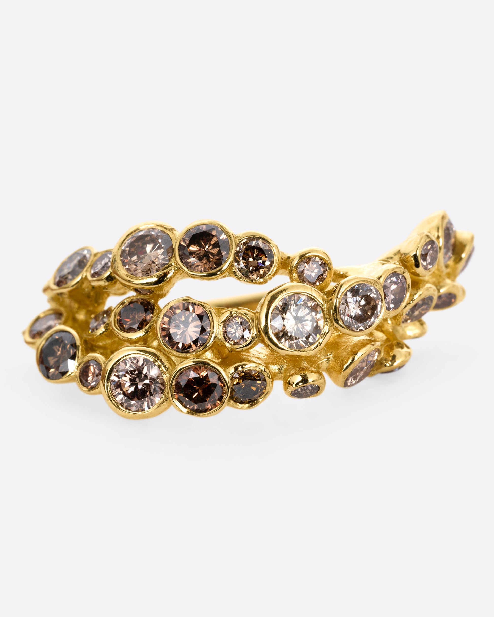 A yellow gold ring with layers of cognac diamonds, shown from the front.