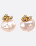 A pair of yellow gold stud earrings with diamond and orange sapphire clusters atop two pink freeform Keshi pearls, shown from the front.